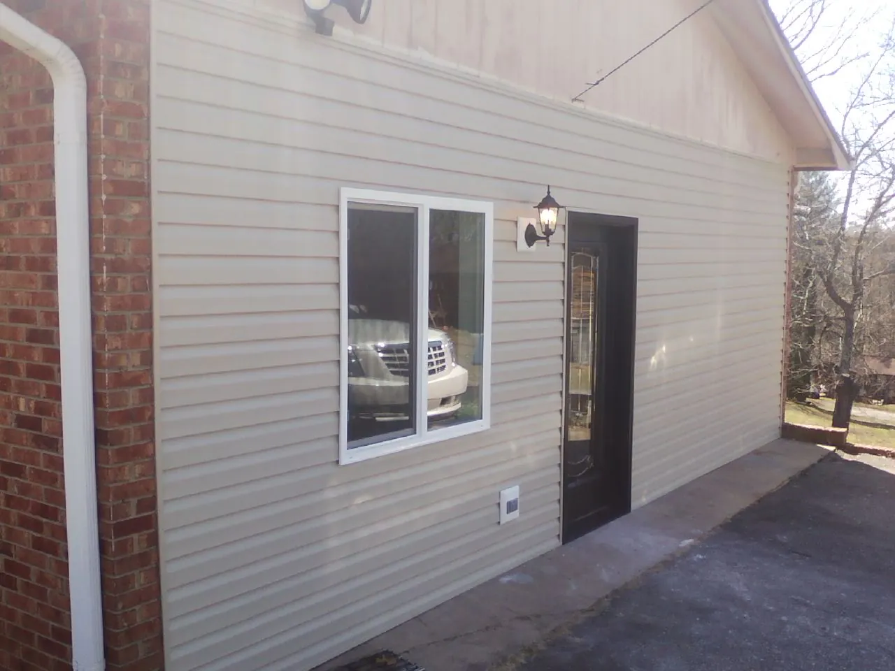 New vinyl siding and entry door on a room addition in Farmington